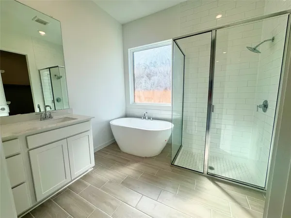 a spacious bathroom with a double vanity sink mirror and shower