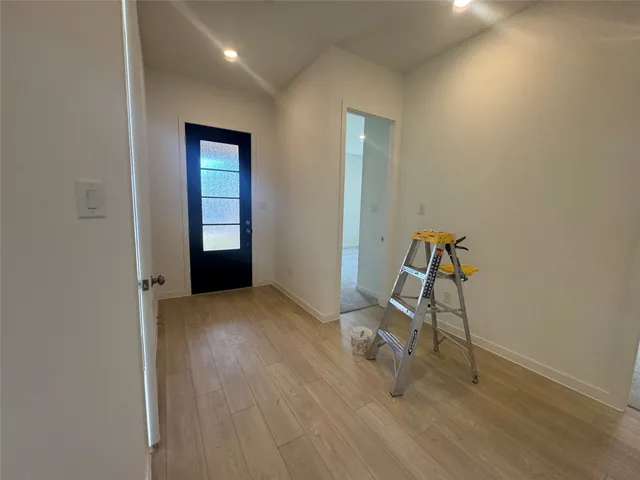 a view of a room with wooden floor and windows