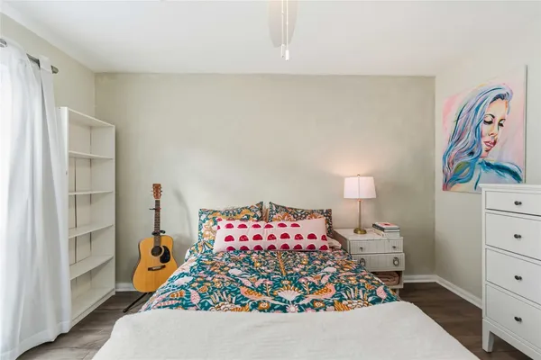 a bedroom with a bed and a large window