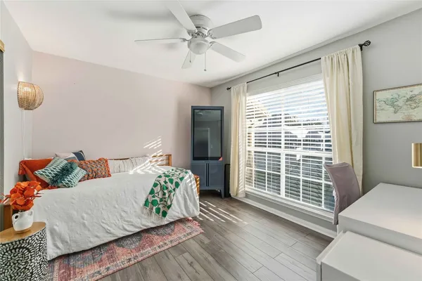 a bedroom with a bed and wooden floor