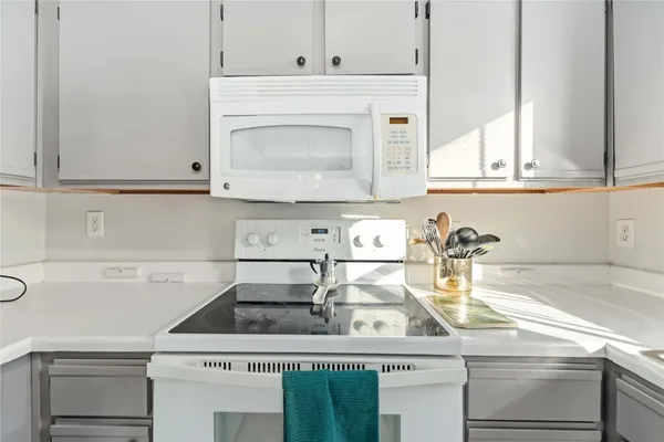 a stove top oven sitting inside of a kitchen
