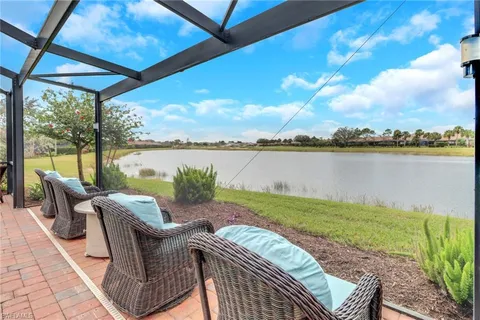 a view of swimming pool with outdoor seating and lake