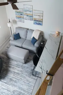 a view of living room with furniture and wooden floor