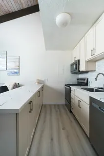 a kitchen with a sink cabinets and window