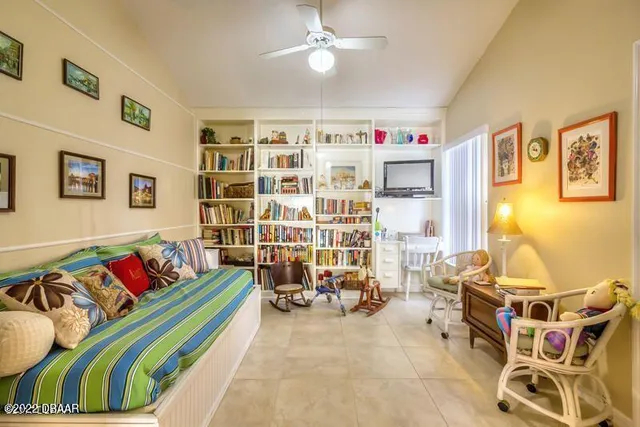 a living room with furniture gym equipment and a chandelier