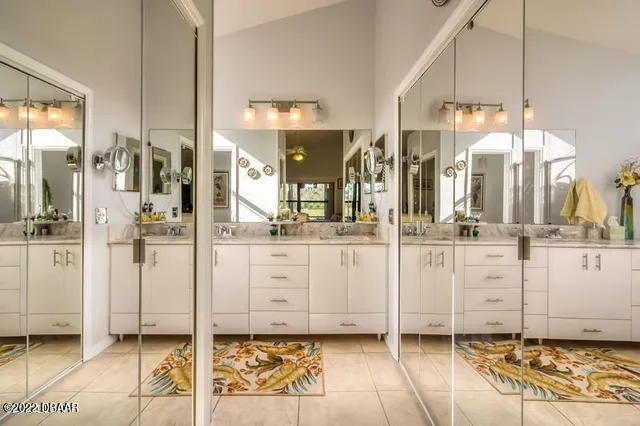 a view of a bathroom with sink mirror and