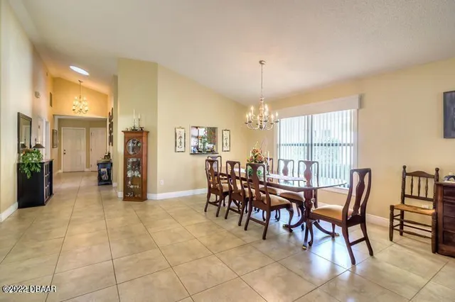 a view of a dining room with furniture and chandelier