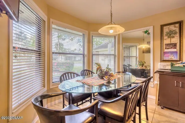 a dining room with furniture and window