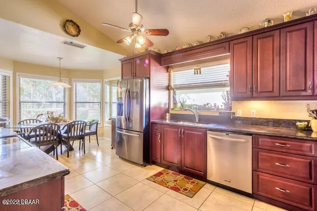 a open kitchen with stainless steel appliances granite countertop a stove and refrigerator