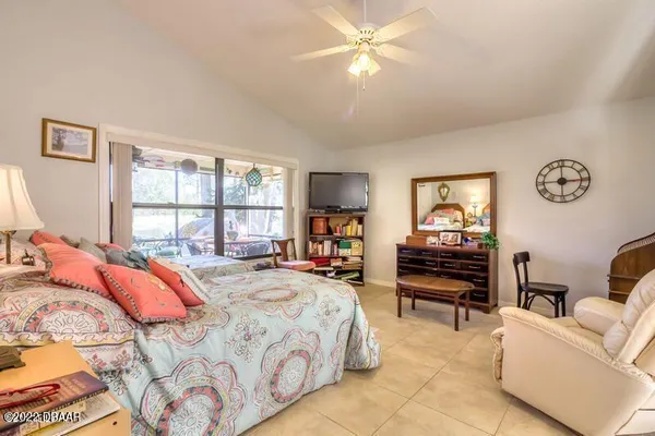 a bedroom with a bed and a large window
