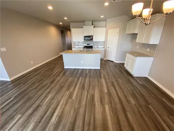a view of kitchen with sink and refrigerator