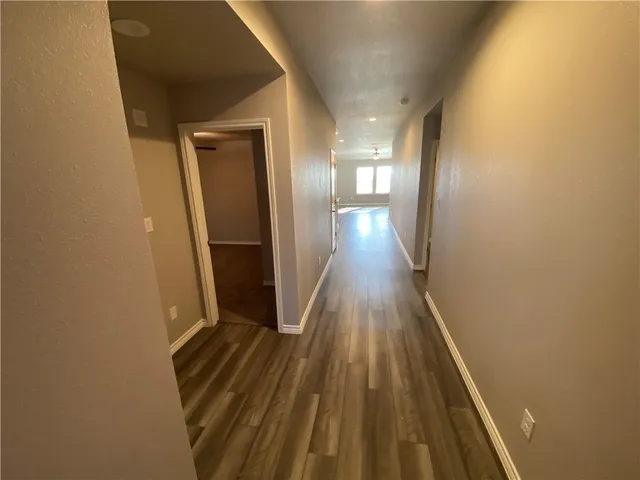 a view of gallery with wooden floor
