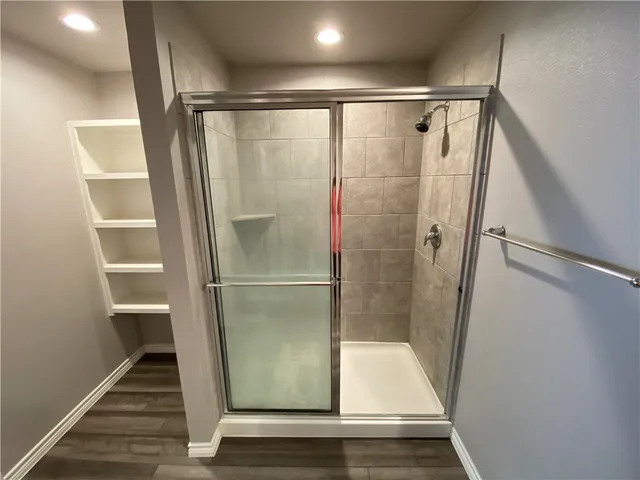 a bathroom with a glass shower door