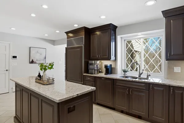 a kitchen with stainless steel appliances granite countertop wooden cabinets a sink and a granite counter tops