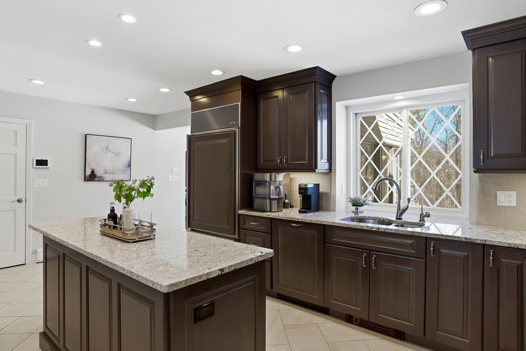 10 Bridle Path North Andover, MA 01845 - Photo 12 of 42 a kitchen with stainless steel appliances granite countertop wooden cabinets a sink and a granite counter tops