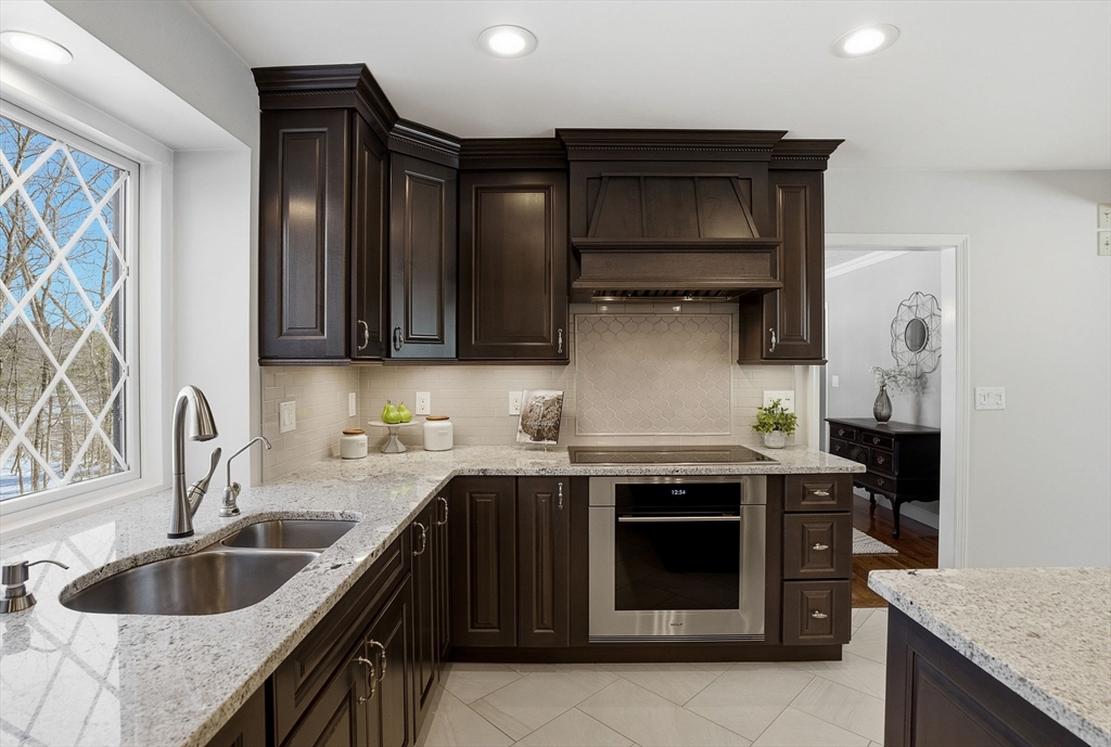 10 Bridle Path North Andover, MA 01845 - Photo 13 of 42 a kitchen with stainless steel appliances granite countertop a sink and a stove