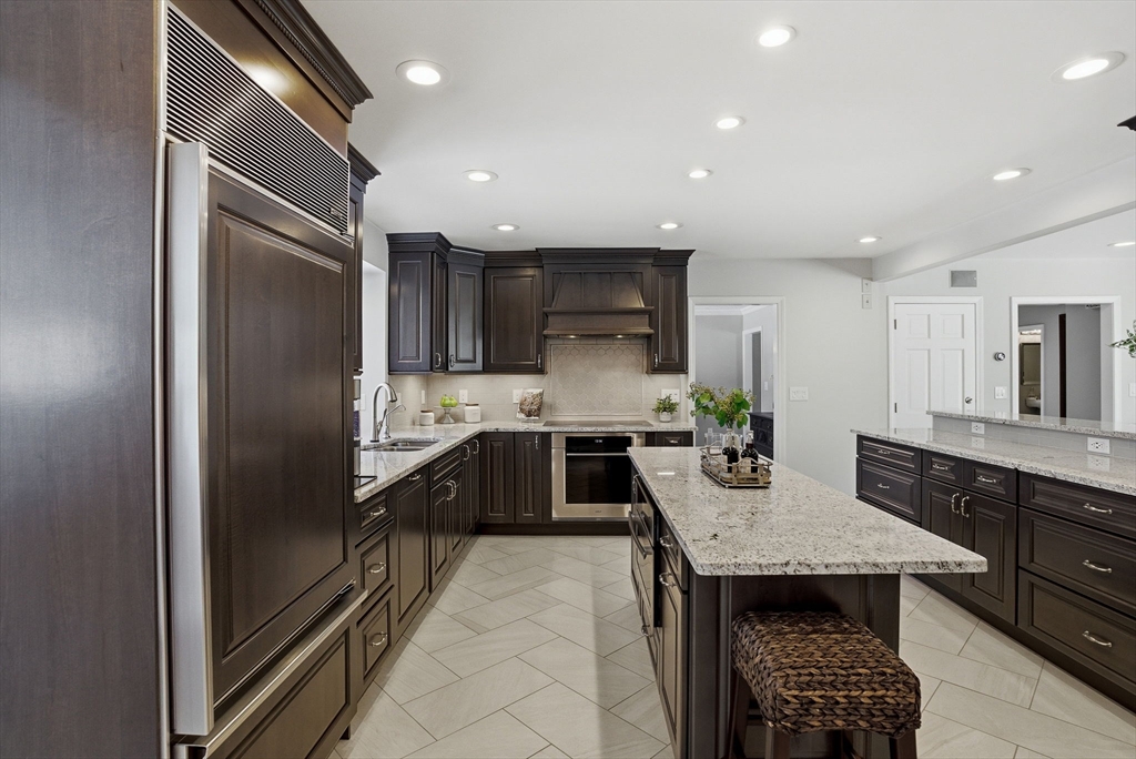 10 Bridle Path North Andover, MA 01845 - Photo 17 of 42 a kitchen with granite countertop stainless steel appliances a sink and counter space