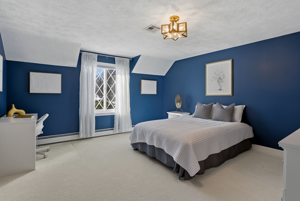 10 Bridle Path North Andover, MA 01845 - Photo 30 of 42 a bedroom with a bed and painting on the wall