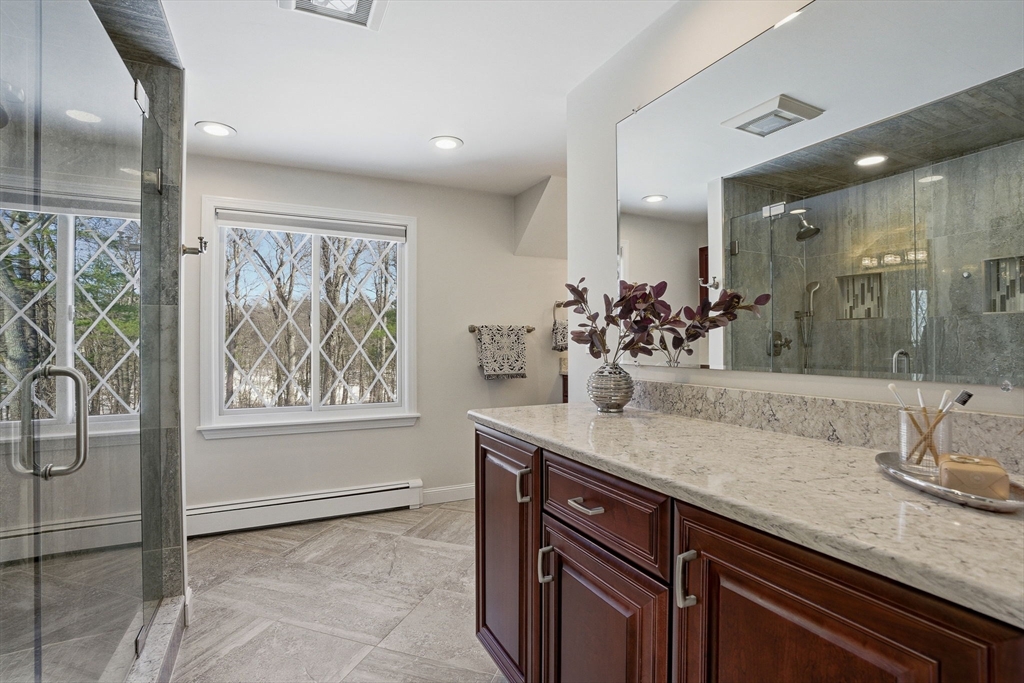 10 Bridle Path North Andover, MA 01845 - Photo 38 of 42 a bathroom with a granite countertop sink a large mirror and a shower