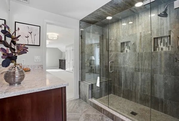 a bathroom with a shower sink and mirror