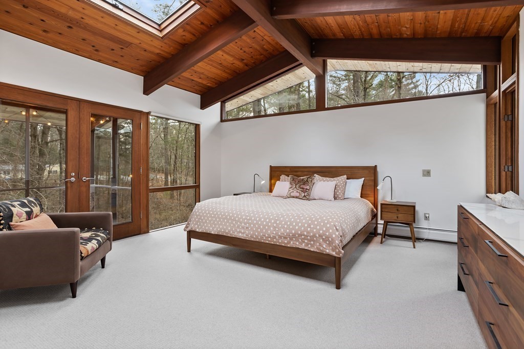 88 Heald Road Carlisle, MA 01741 - Photo 18 of 42 a bedroom with a bed and a balcony