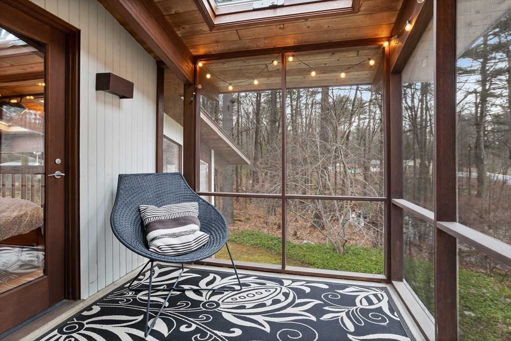 88 Heald Road Carlisle, MA 01741 - Photo 20 of 42 a view of a porch with a table and chairs