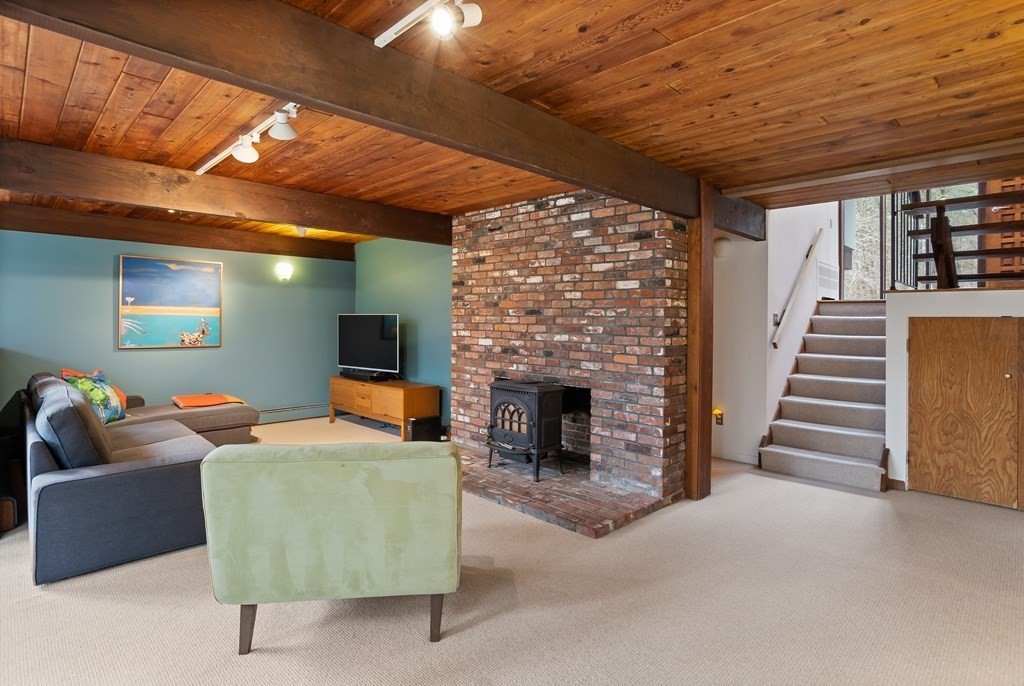 88 Heald Road Carlisle, MA 01741 - Photo 25 of 42 a living room with furniture and a fireplace