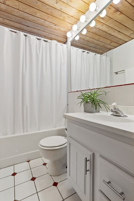 88 Heald Road Carlisle, MA 01741 - Photo 34 of 42 a bathroom with a sink a toilet and shower curtain