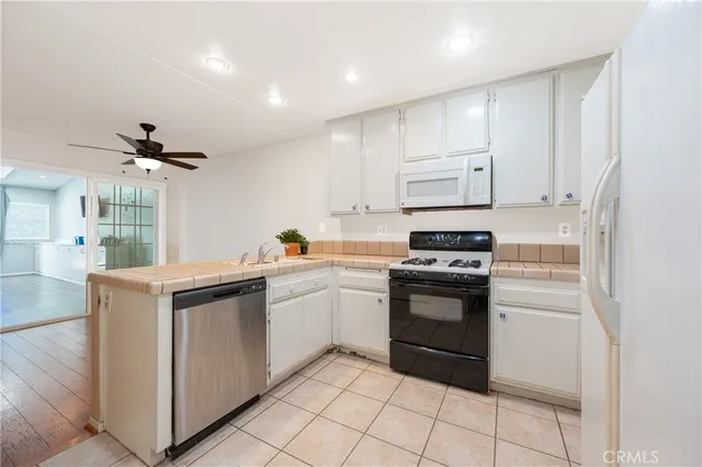 a kitchen with stainless steel appliances granite countertop a stove and a refrigerator