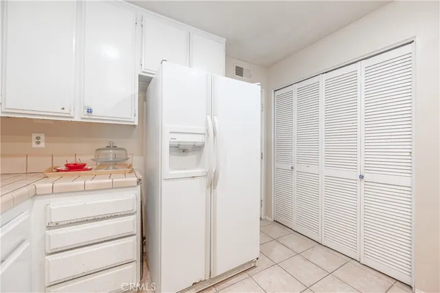 a white refrigerator freezer and a stove sitting inside of a kitchen