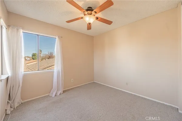a view of a room with closet and a chandelier fan