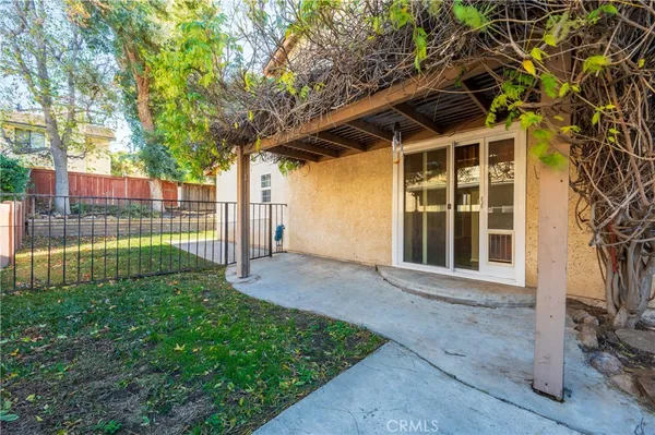 a aerial view of a house with swimming pool and a chairs