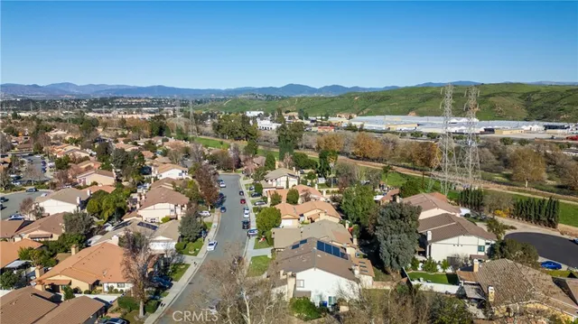 an aerial view of residential houses with outdoor space and trees