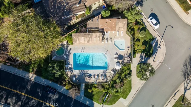a sign of golf club on a wall under a tree