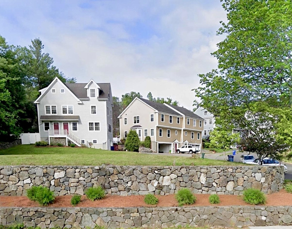 2 B Gates Lane, Unit B Wakefield, MA 01880 - Photo 2 of 42 a front view of a house with a yard