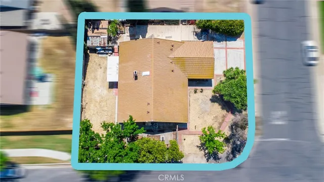 an aerial view of a house with a yard
