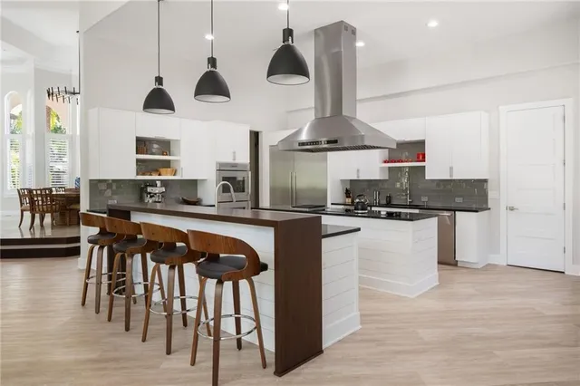 a kitchen with stainless steel appliances granite countertop a stove a sink and a refrigerator