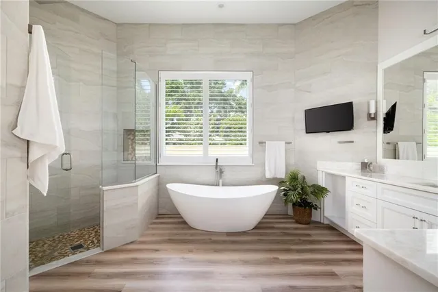 a spacious bathroom with a bathtub and sink