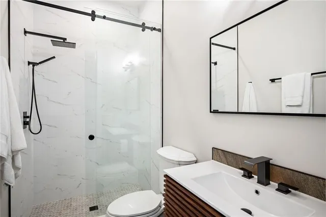 a bathroom with a sink toilet and shower