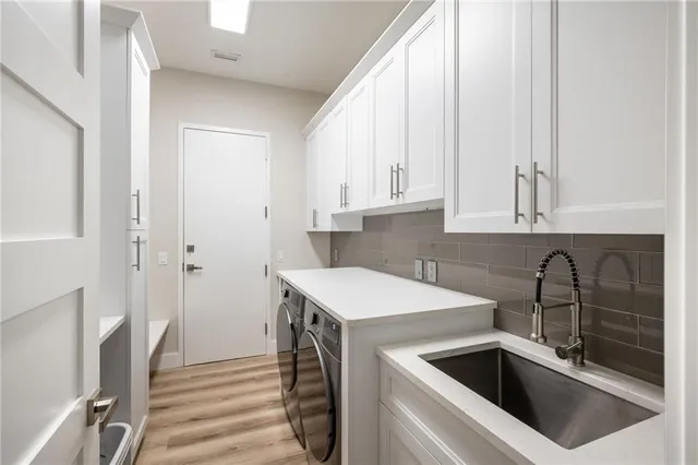 a kitchen with a sink cabinets and appliances