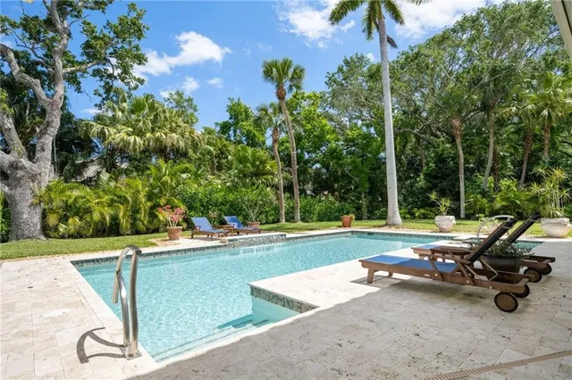 a view of a swimming pool and lounge chair
