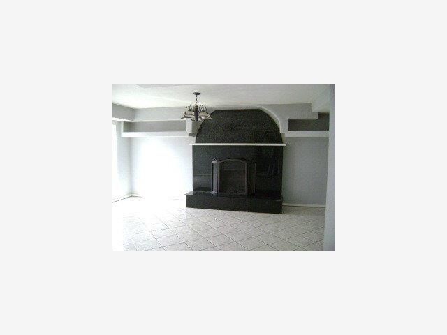 1579 Michigan Avenue San Jose, CA 95002 - Photo 2 of 8 a living room with a chair and a fireplace