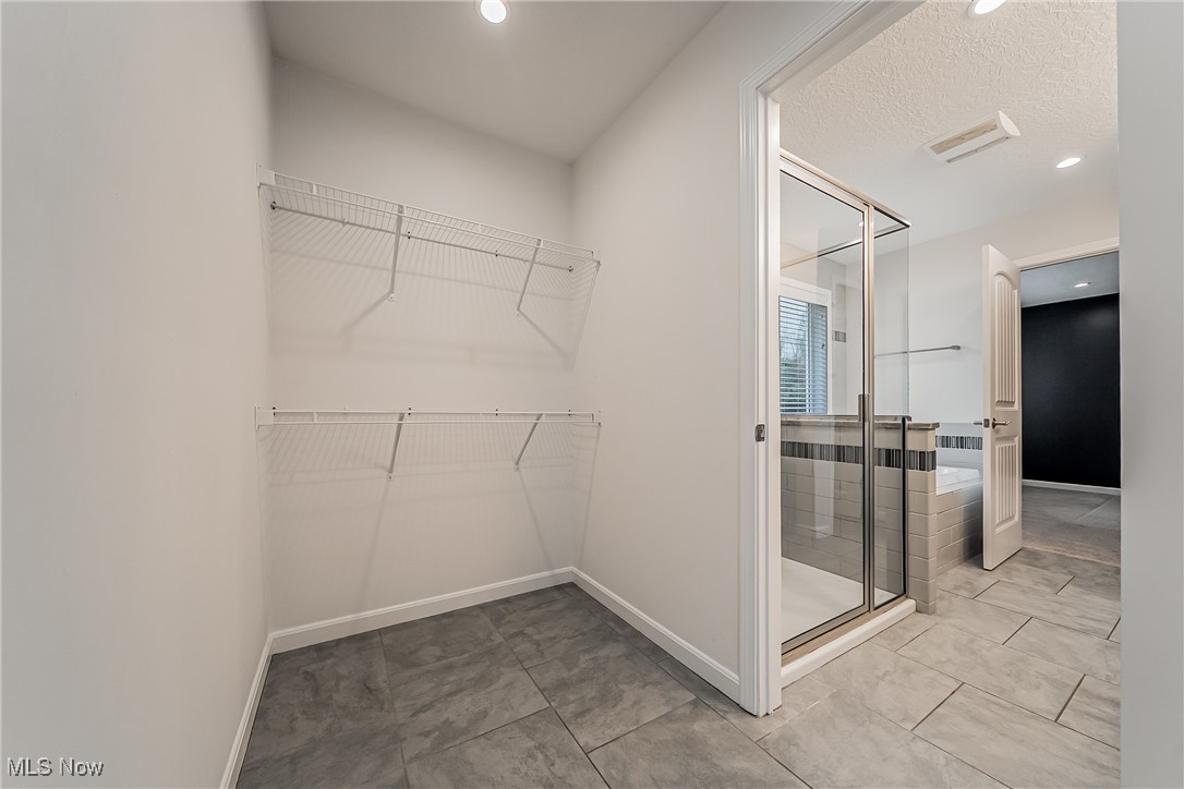 5270 Brainard Road Solon, OH 44139 - Photo 24 of 45 Spacious Primary suite closet entry from bathroom with light tile patterned floors