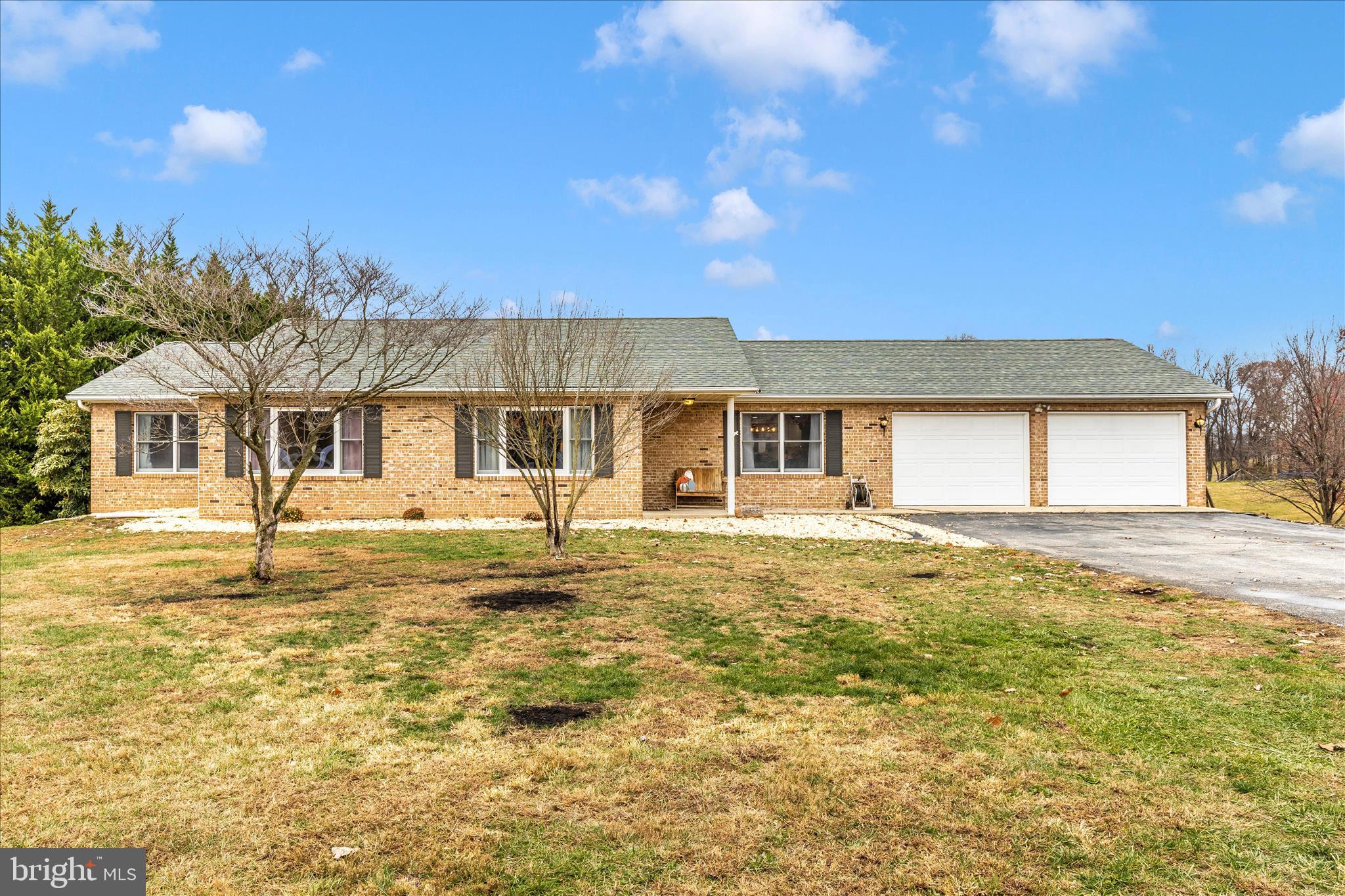 a front view of a house with a garden and yard