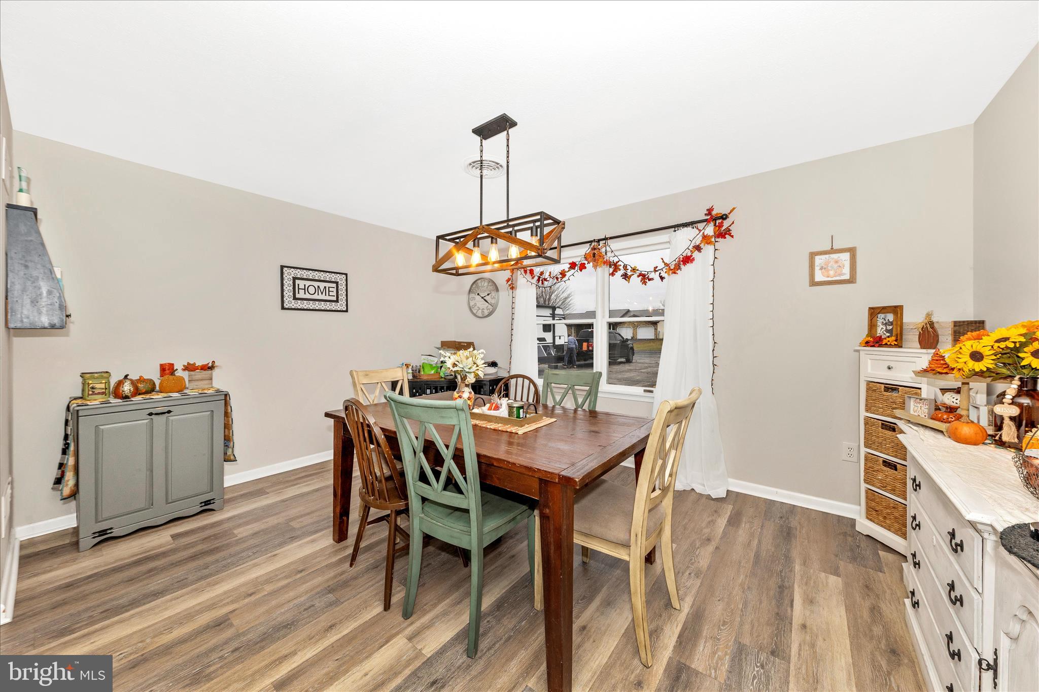 126 Game Trail Road Falling Waters, WV 25419 - Photo 13 of 41 a view of a dining room with furniture and wooden floor