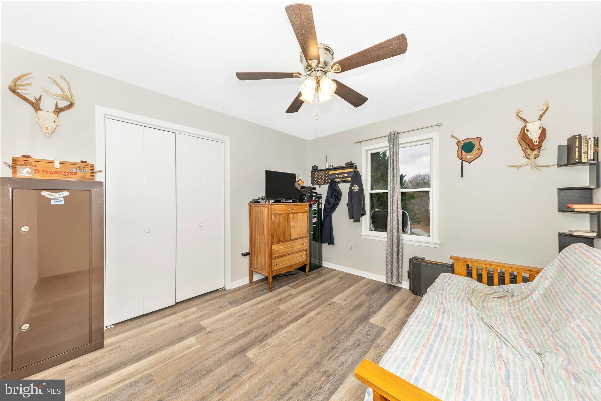 126 Game Trail Road Falling Waters, WV 25419 - Photo 27 of 41 a bedroom with a bed and a chandelier