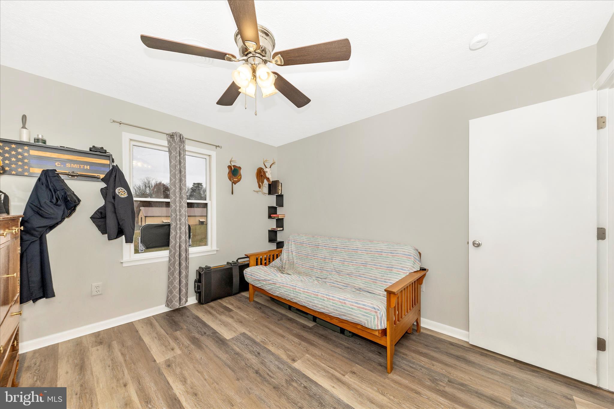 126 Game Trail Road Falling Waters, WV 25419 - Photo 28 of 41 a bedroom with a bed and wooden floor