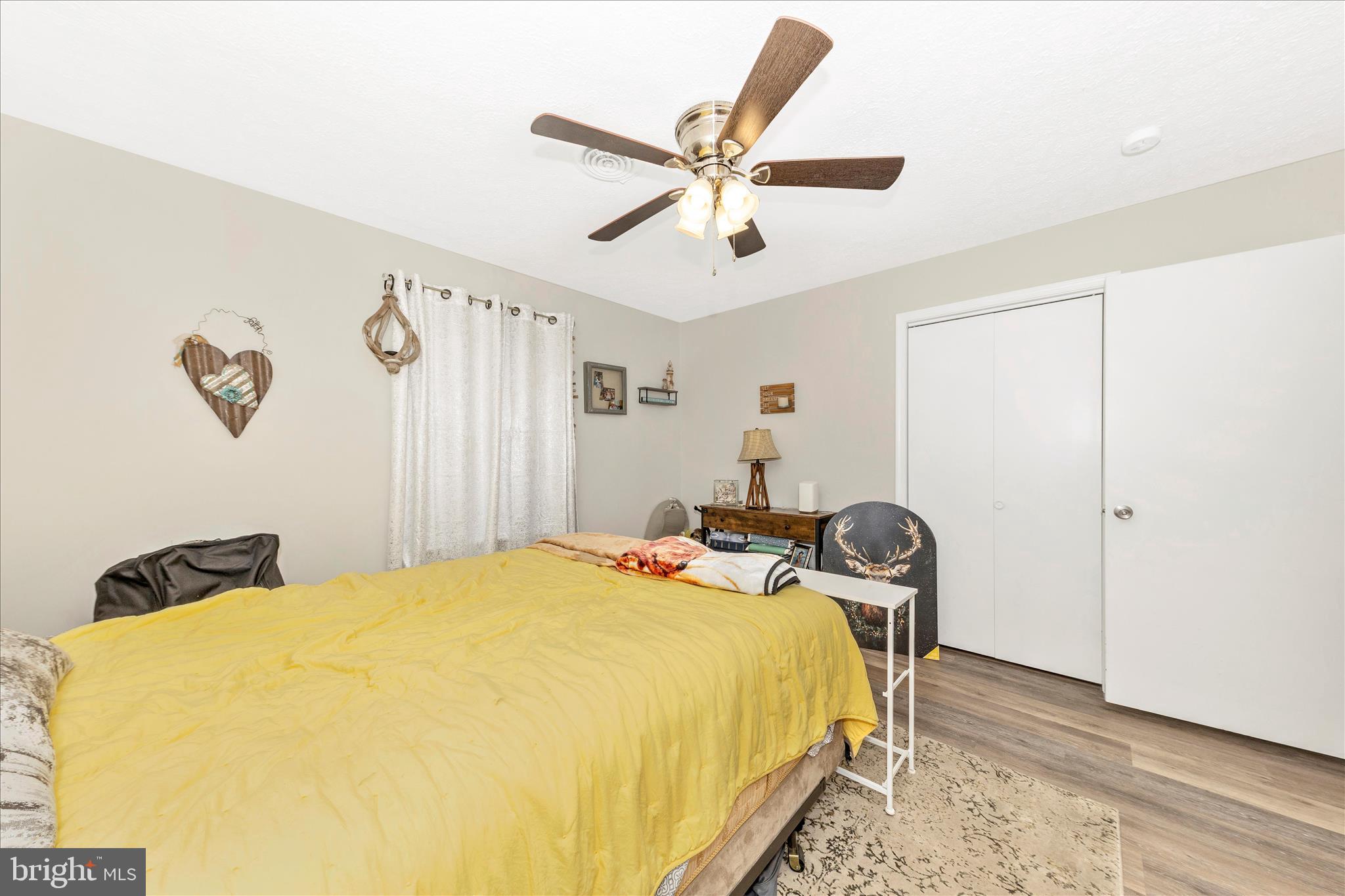 126 Game Trail Road Falling Waters, WV 25419 - Photo 30 of 41 a bedroom with a bed and wooden floor