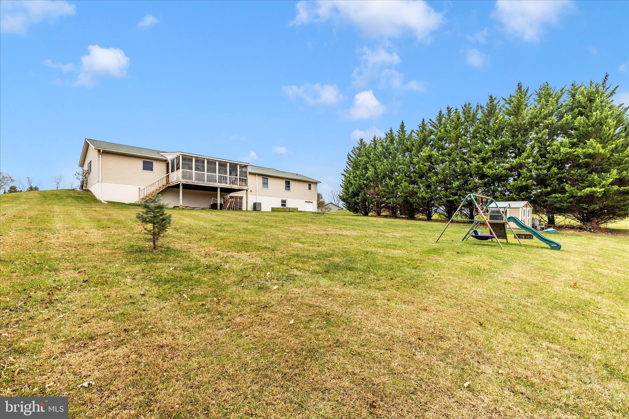 126 Game Trail Road Falling Waters, WV 25419 - Photo 36 of 41 a view of a swimming pool with an outdoor seating and a yard