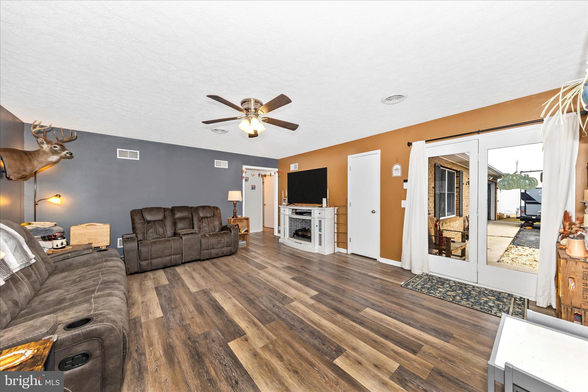 126 Game Trail Road Falling Waters, WV 25419 - Photo 7 of 41 a large bedroom with a large bed a flat tv screen and a chandelier
